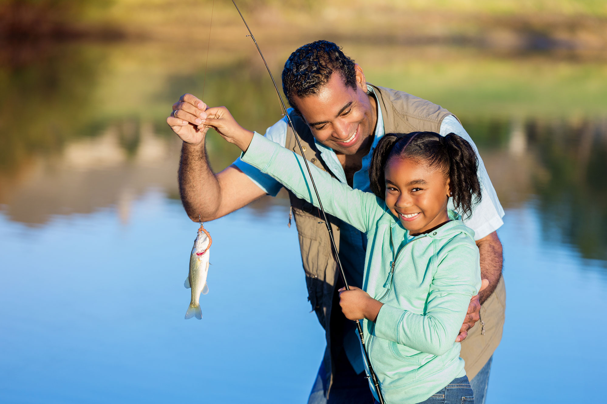 Father and daughter catching a fish