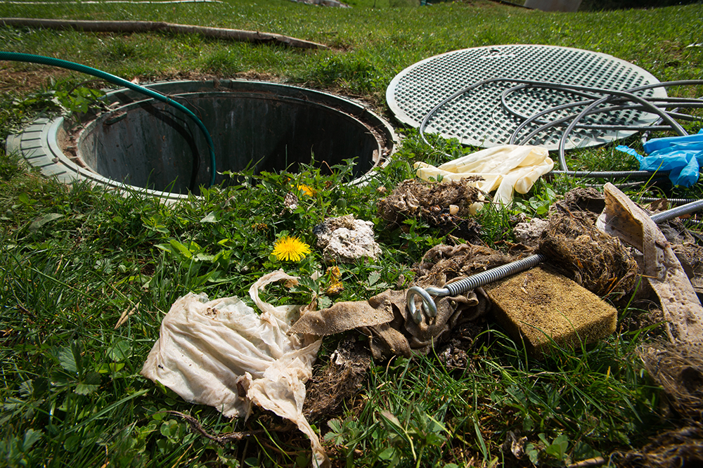 Septic system opening being inspected